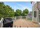 Expansive wooden deck with white railings, ideal for outdoor grilling and enjoying the surrounding lush greenery at 10452 Quiet Bay Ct, Charlotte, NC 28278