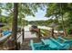 This lakeside house has a dock with a boat and kayaks at 10452 Quiet Bay Ct, Charlotte, NC 28278