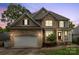Beautiful two-story home boasts a stone and siding exterior with a well-manicured front yard at 10452 Quiet Bay Ct, Charlotte, NC 28278