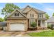 Beautiful two-story home boasts a stone and siding exterior with a well-manicured front yard at 10452 Quiet Bay Ct, Charlotte, NC 28278