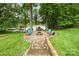 View of the beautiful backyard firepit area near the lake at 10452 Quiet Bay Ct, Charlotte, NC 28278