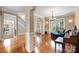 Grand foyer with hardwood floors and natural light leads into a living room with stylish furnishings at 10452 Quiet Bay Ct, Charlotte, NC 28278