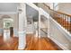 Bright foyer showcases gleaming hardwood floors, elegant staircase, and classic architectural details at 10452 Quiet Bay Ct, Charlotte, NC 28278