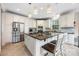 A stunning white kitchen featuring stainless appliances, granite counters, and stylish pendant lighting at 10452 Quiet Bay Ct, Charlotte, NC 28278