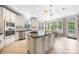 Bright eat-in kitchen featuring stainless appliances, granite counters, and sunny breakfast nook at 10452 Quiet Bay Ct, Charlotte, NC 28278