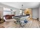Spacious living area featuring a billiard table, stone fireplace, and comfortable seating, perfect for entertaining at 10452 Quiet Bay Ct, Charlotte, NC 28278