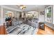 Open-concept living room features an extra-large sectional sofa, accent rug and recessed lighting at 10452 Quiet Bay Ct, Charlotte, NC 28278