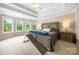A bright main bedroom featuring a trey ceiling, large windows and carpeted floors at 10452 Quiet Bay Ct, Charlotte, NC 28278