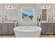Bathroom featuring a soaking tub, double vanities, and a large window for natural light at 1102 Sugar Creek Rd, Indian Land, SC 29707
