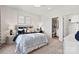 A neutral bedroom with a queen bed, bedside tables, a desk, and ensuite bathroom at 1102 Sugar Creek Rd, Indian Land, SC 29707