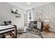 A stylish Bedroom featuring a crib, zebra rug, and animal-themed wall decor and accent wall at 1102 Sugar Creek Rd, Indian Land, SC 29707