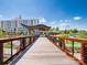 A wooden bridge leads to an outdoor structure on a sunny day with blue skies and community buildings at 1102 Sugar Creek Rd, Indian Land, SC 29707