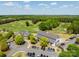 Aerial of golf clubhouse and barn building, with ample parking, set amidst lush greens at 1102 Sugar Creek Rd, Indian Land, SC 29707