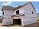 New construction showcasing Tyvek wrapped walls, roof installation, and framed opening of a two-story house at 1102 Sugar Creek Rd, Indian Land, SC 29707
