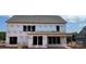 Exterior view of a new construction home showcasing Tyvek wrap, installed roof, and window framing at 1102 Sugar Creek Rd, Indian Land, SC 29707