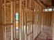 Interior framing featuring stud walls, doorway framing, and visible window framing for natural light at 1102 Sugar Creek Rd, Indian Land, SC 29707