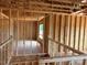 Upstairs interior framing of a home showing the stud walls, roof trusses and window framing at 1102 Sugar Creek Rd, Indian Land, SC 29707