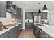 Modern kitchen features gray cabinets, stainless steel appliances, quartz countertops, and hardwood floors at 1102 Sugar Creek Rd, Indian Land, SC 29707