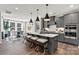 Modern kitchen with gray cabinets, a large island, pendant lighting, and stainless steel appliances at 1102 Sugar Creek Rd, Indian Land, SC 29707