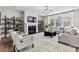 Bright living room featuring a fireplace, modern lighting, and comfortable seating arrangement at 1102 Sugar Creek Rd, Indian Land, SC 29707