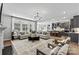 Open-concept living area with a fireplace, modern lighting, and a view into the kitchen at 1102 Sugar Creek Rd, Indian Land, SC 29707