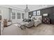 Spacious main bedroom with sitting area, large windows, and a dark accent wall at 1102 Sugar Creek Rd, Indian Land, SC 29707