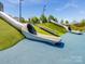 Modern slides built into a grassy hillside on a community playground at 1102 Sugar Creek Rd, Indian Land, SC 29707