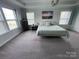 Another view of the bedroom with tray ceilings, ample natural light, and calming decor at 112 Paradise Hills Cir, Mooresville, NC 28115