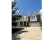 Inviting brick and siding home featuring a well-maintained lawn and attached garage at 112 Paradise Hills Cir, Mooresville, NC 28115