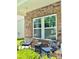 Cozy front porch with outdoor seating and a charming brick facade at 112 Paradise Hills Cir, Mooresville, NC 28115