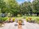 Secluded backyard patio featuring numerous potted plants and mature trees at 11332 Ridge Oak Dr, Charlotte, NC 28273
