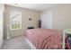 Bright bedroom featuring a large window and double door closet at 11332 Ridge Oak Dr, Charlotte, NC 28273