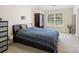 This spacious bedroom features a large window, wardrobe, and stylish blue bedding at 11332 Ridge Oak Dr, Charlotte, NC 28273