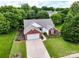 Aerial view of a charming brick and white home with well-manicured lawn and mature trees at 11332 Ridge Oak Dr, Charlotte, NC 28273