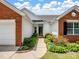 Lovely brick and white home featuring a manicured lawn and a welcoming front entrance at 11332 Ridge Oak Dr, Charlotte, NC 28273