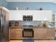 Modern kitchen featuring stainless appliances, white cabinets, and stylish backsplash at 11332 Ridge Oak Dr, Charlotte, NC 28273