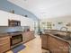 Stylish kitchen features modern cabinetry, stainless steel appliances, and dining nook by the window at 11332 Ridge Oak Dr, Charlotte, NC 28273