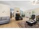 Open concept living room with modern furniture, light floors, and seamless flow to kitchen at 11332 Ridge Oak Dr, Charlotte, NC 28273