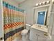 Bright bathroom features decorative shower curtain, white vanity, and neutral wall paint at 1176 Constitution Park Blvd, Rock Hill, SC 29732