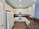 Updated kitchen with white cabinets and granite countertops, tile backsplash and stainless appliances at 1176 Constitution Park Blvd, Rock Hill, SC 29732