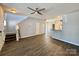 Open-concept living room with hard wood floors leading to stairs and white kitchen cabinets at 1176 Constitution Park Blvd, Rock Hill, SC 29732