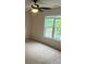 Bedroom with neutral carpet, ceiling fan, and large window at 135 Locomotive Ln # 106, Mooresville, NC 28115