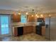 Updated kitchen with wood cabinets, black appliances, and back door at 135 Locomotive Ln # 106, Mooresville, NC 28115