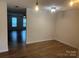 Cozy living room features a pendant light, neutral walls, and wood-look floors at 135 Locomotive Ln # 106, Mooresville, NC 28115