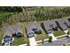 An aerial view of the home showcasing its location in a neighborhood with mature trees and manicured lawns at 1360 Dali Blvd, Mount Holly, NC 28120
