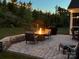 Inviting backyard patio features a fire pit, comfortable seating, and ambient string lights for cozy outdoor evenings at 1360 Dali Blvd, Mount Holly, NC 28120