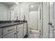 Bright bathroom with granite counters, white cabinets, and an adjoining room featuring a shower at 1360 Dali Blvd, Mount Holly, NC 28120
