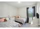 Neutral bedroom with twin beds, soft gray bedding, and a window with natural light at 1360 Dali Blvd, Mount Holly, NC 28120