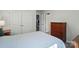 Comfortable bedroom with a blue patterned comforter, hardwood dresser and ensuite bathroom at 1360 Dali Blvd, Mount Holly, NC 28120