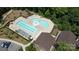 Aerial view of the community pool showcasing lounge chairs, umbrellas, and a clubhouse for summer fun at 1360 Dali Blvd, Mount Holly, NC 28120
